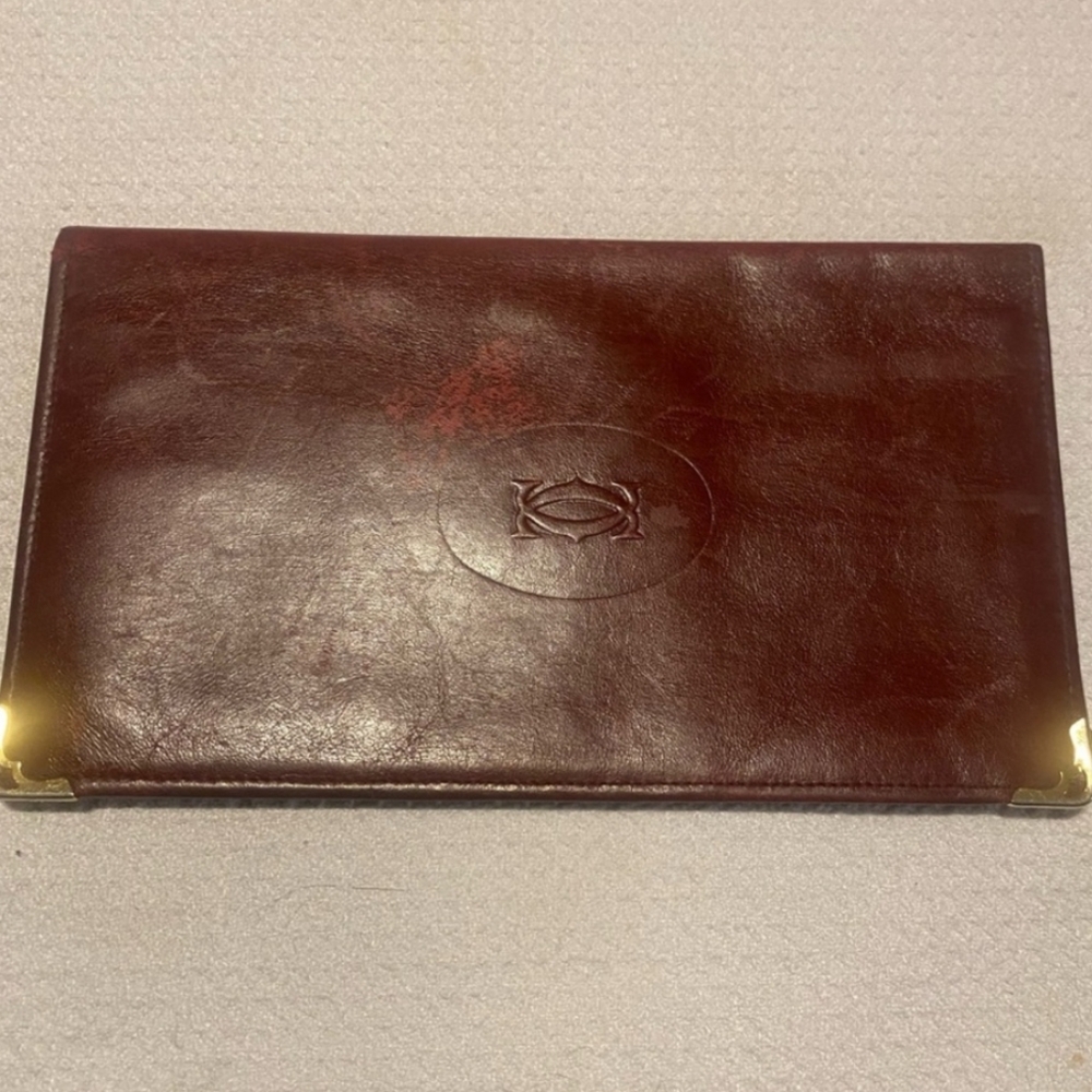 Elegant Cartier burgundy leather wallet featuring Gold Accents Preloved